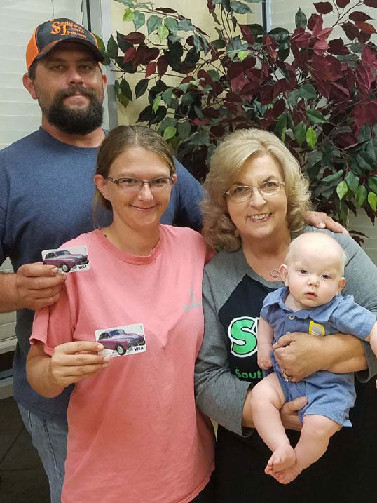 The winners of our EZ car care gift card drawing showing off their gift cards